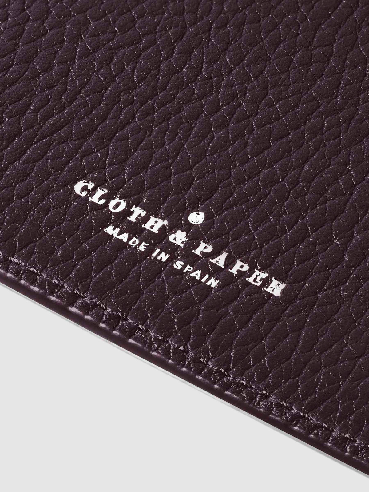 Closeup of silver stamping on leather folio.