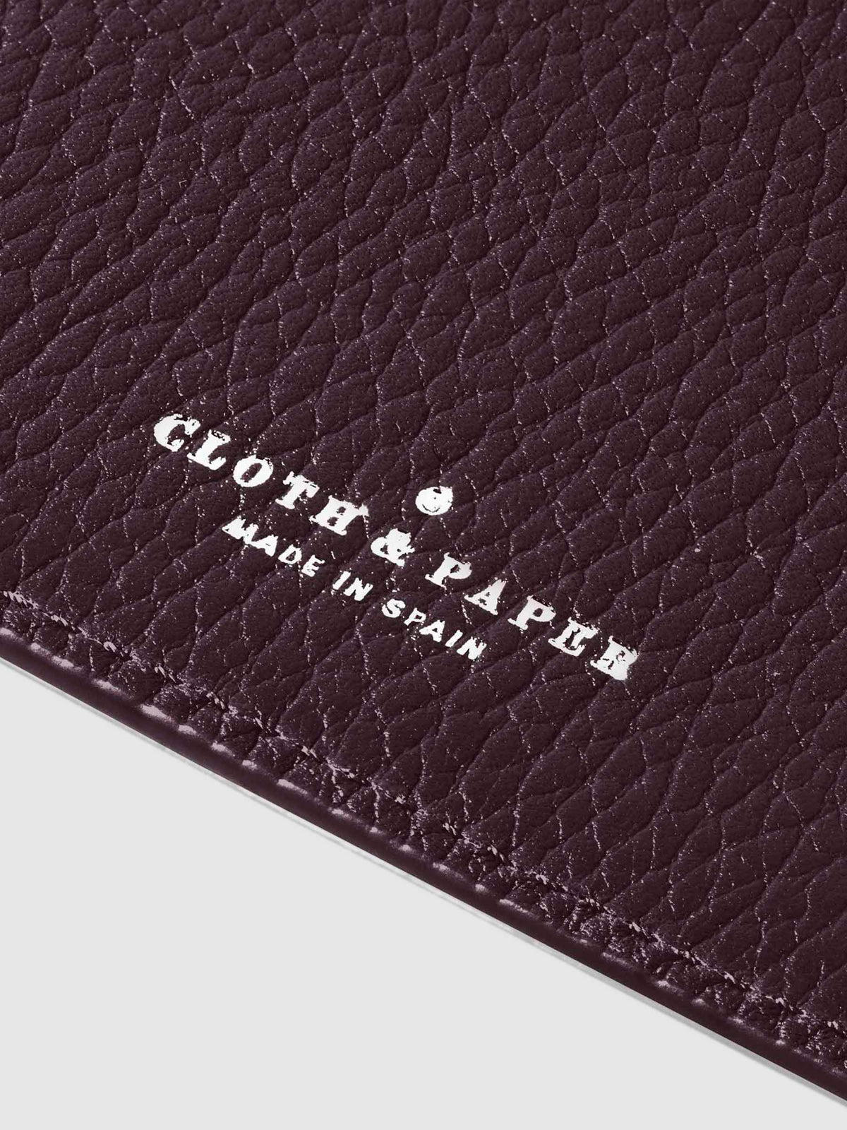 Closeup of silver stamping on leather folio.