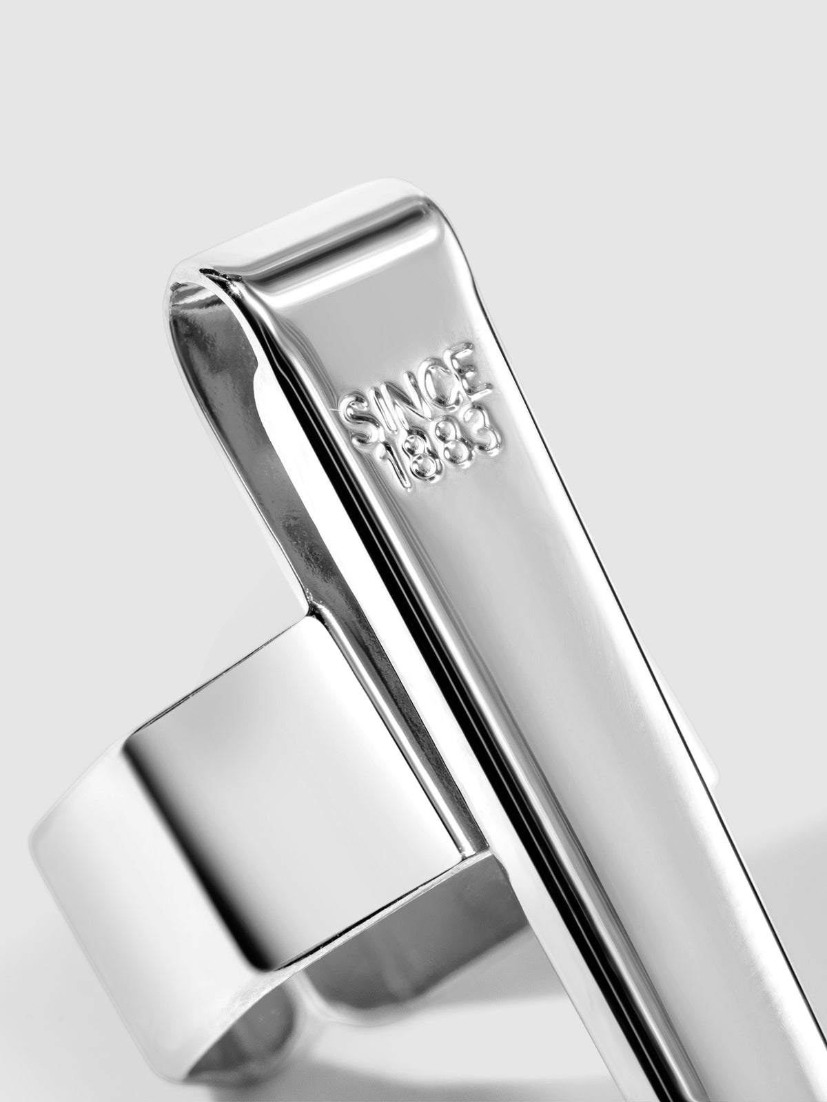 Standard silver clip displayed on a neutral background. Closeup of text reads "Since 1883"