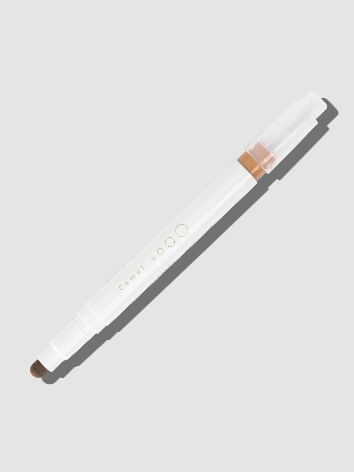 Camel highlighter with tip exposed and cap posted to the end of its barrel on a neutral background.
