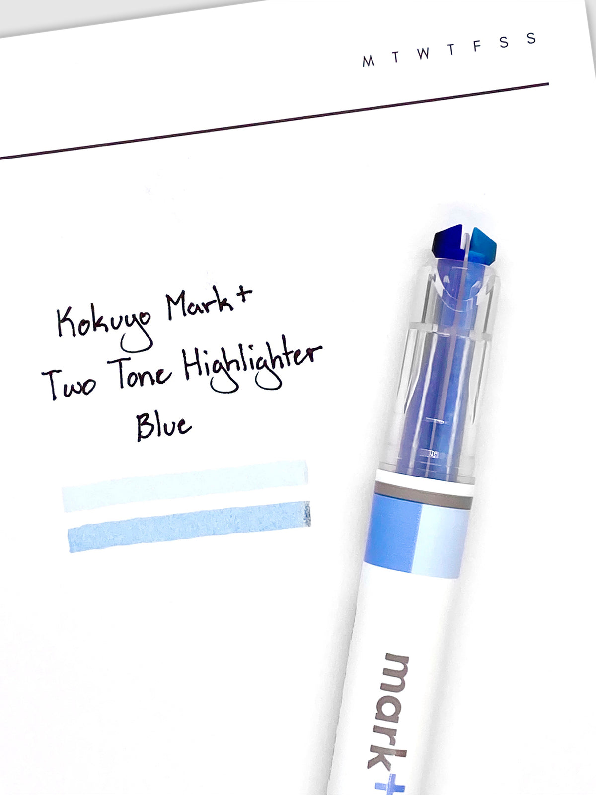 Highlighter resting on a sheet of paper displaying highlight samples from both nibs and ink colors.