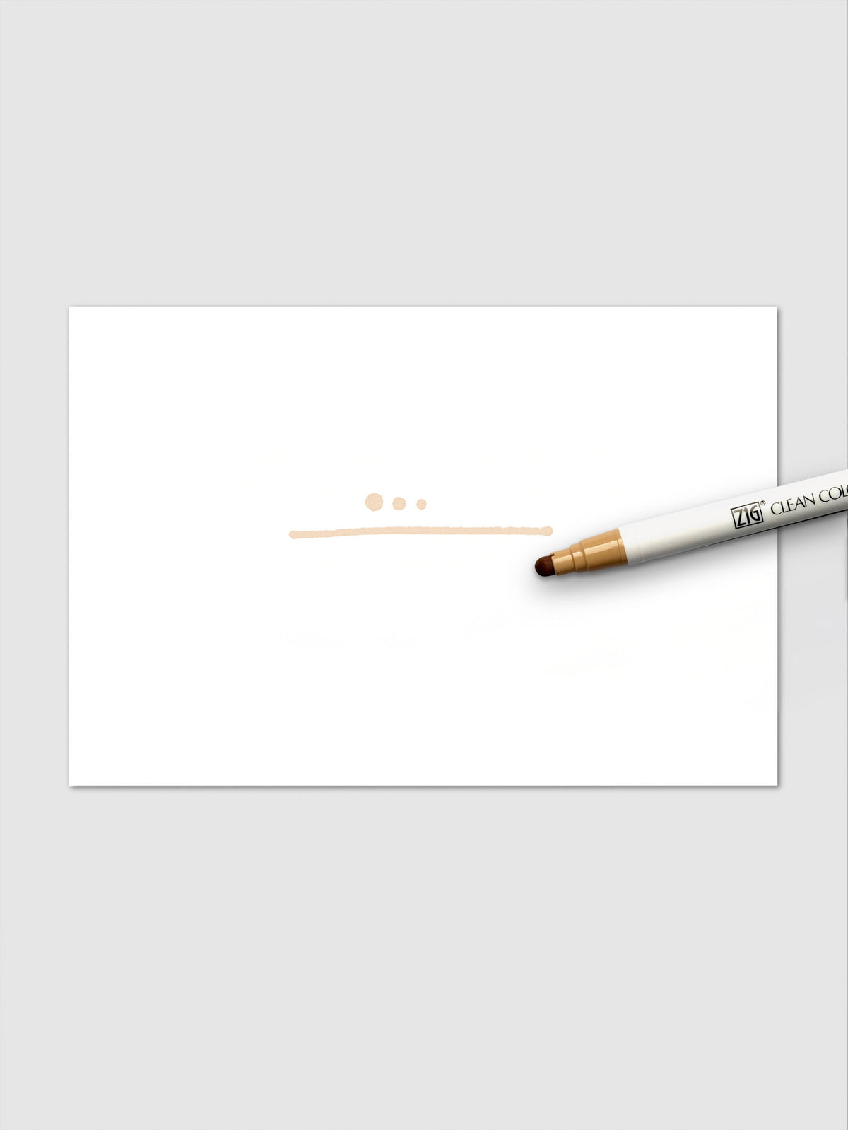 Oatmeal marker shown creating pastel dots and a smooth line on white paper surface.