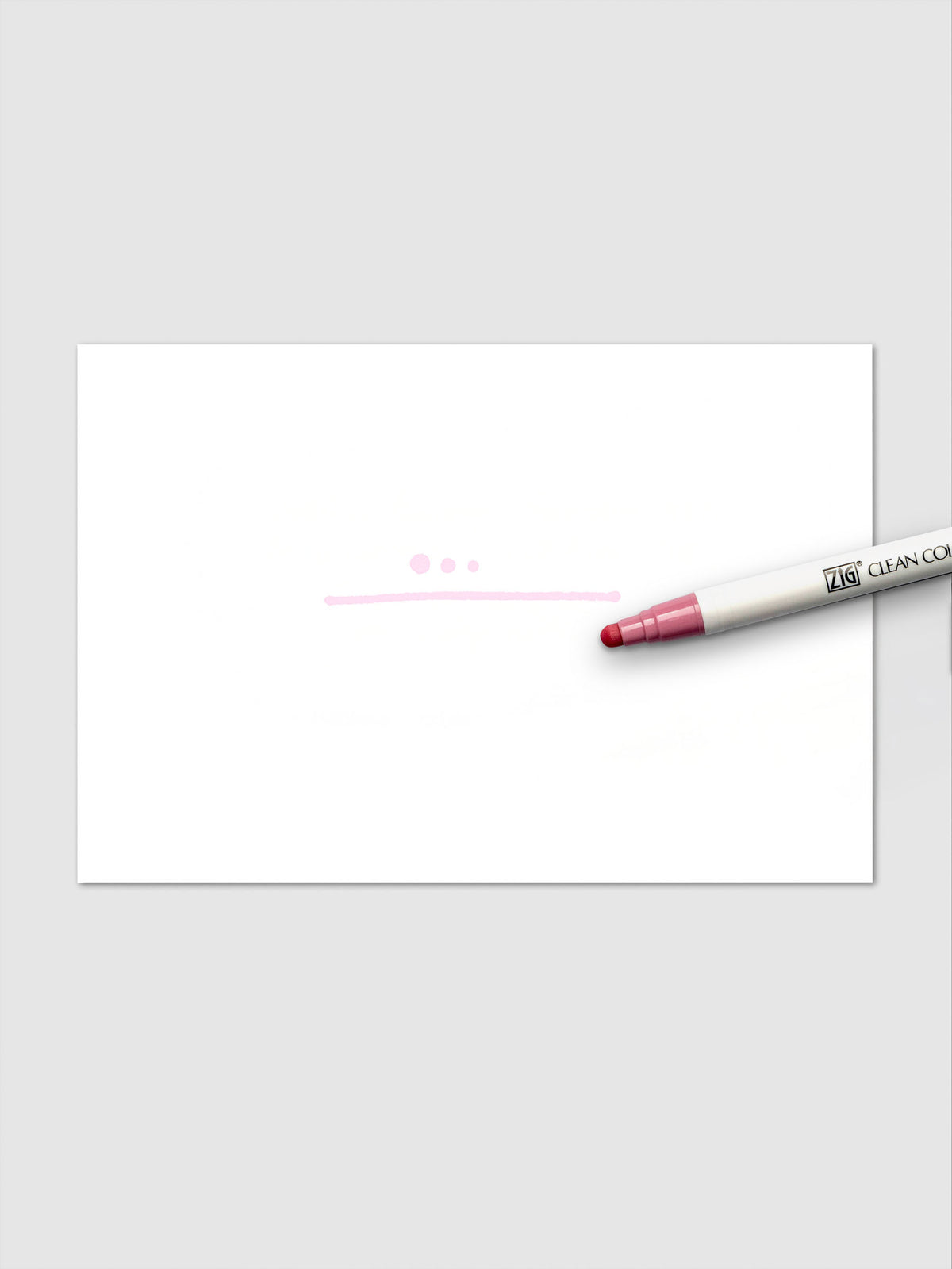 The Pale Rose marker creates three circular dots and a light pink line on white paper, demonstrating its soft pigmentation and flexible linework.