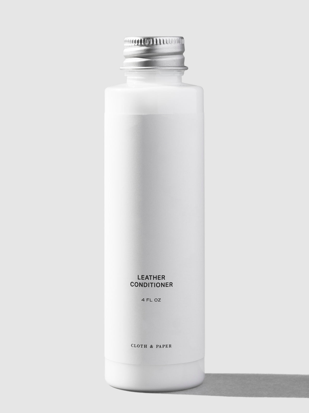 Leather conditioner, Cloth and Paper. Conditioner displayed on a neutral background.