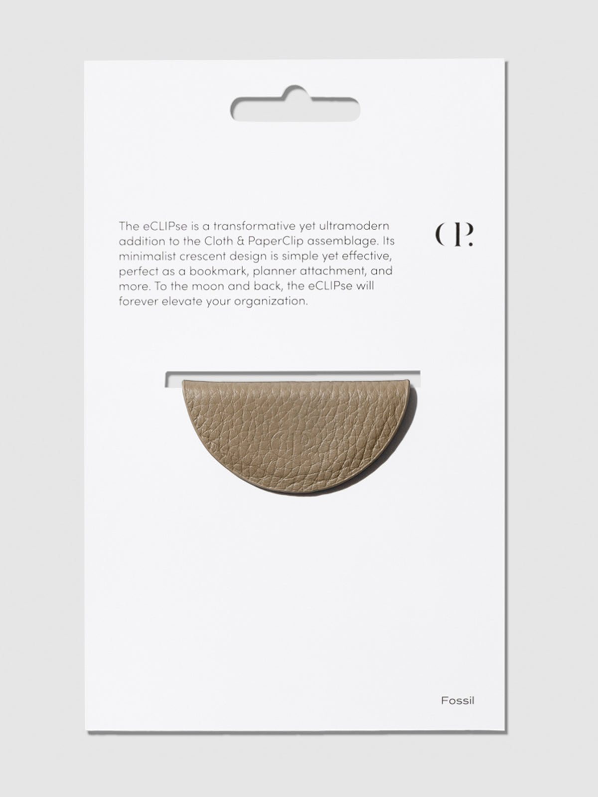 Brown bookmark shown in its packaging on a neutral background.