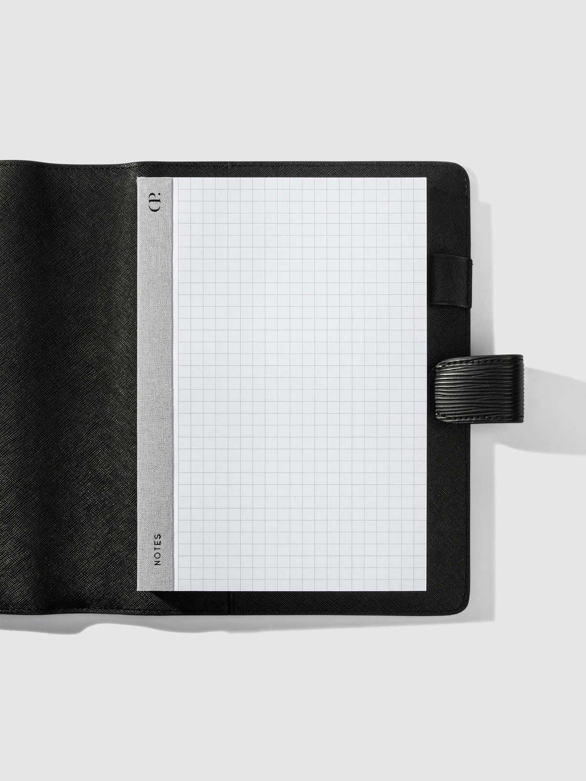 Notepad in use inside a black leather folio.