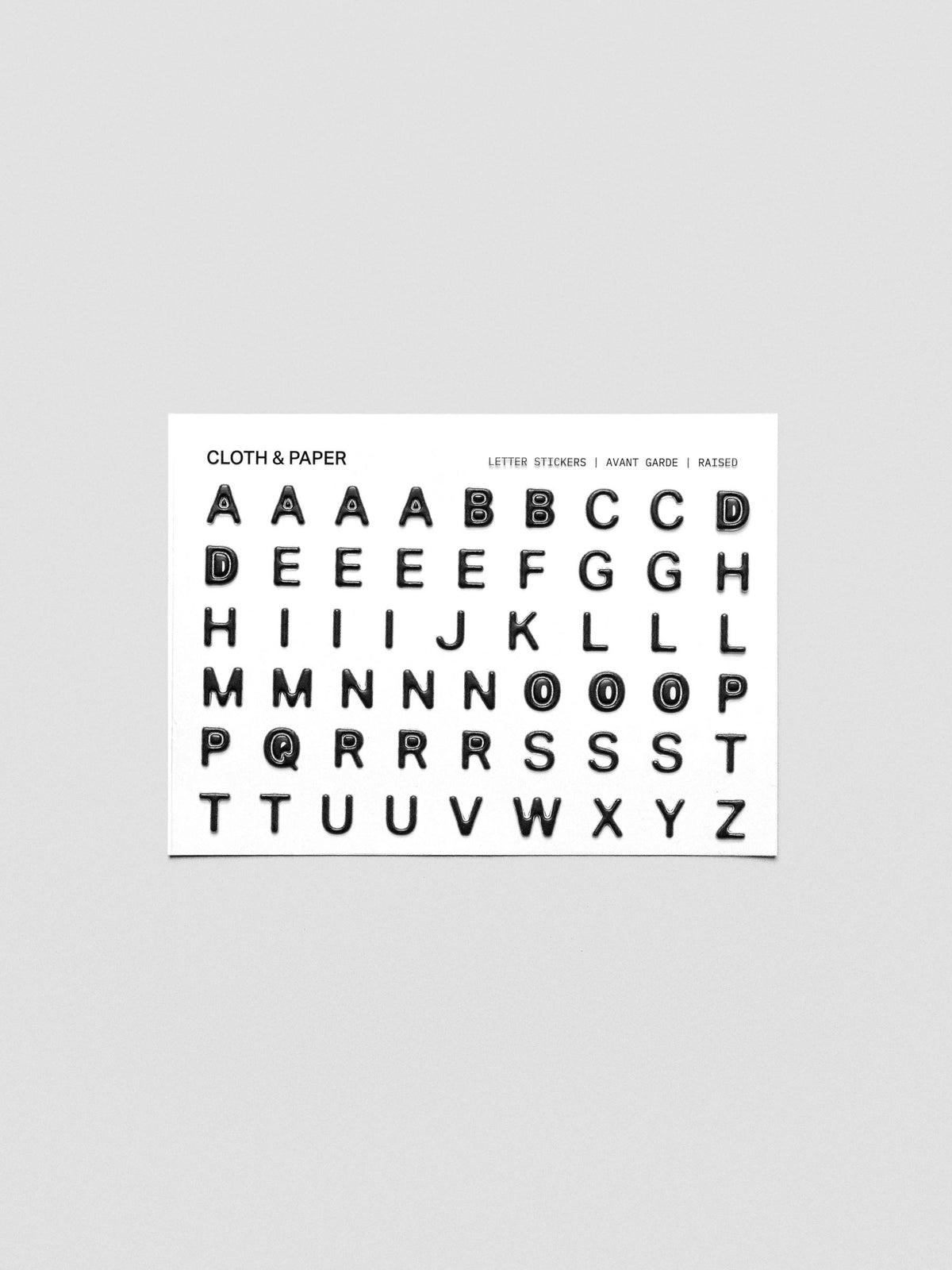 One sheet of black raised letter stickers.