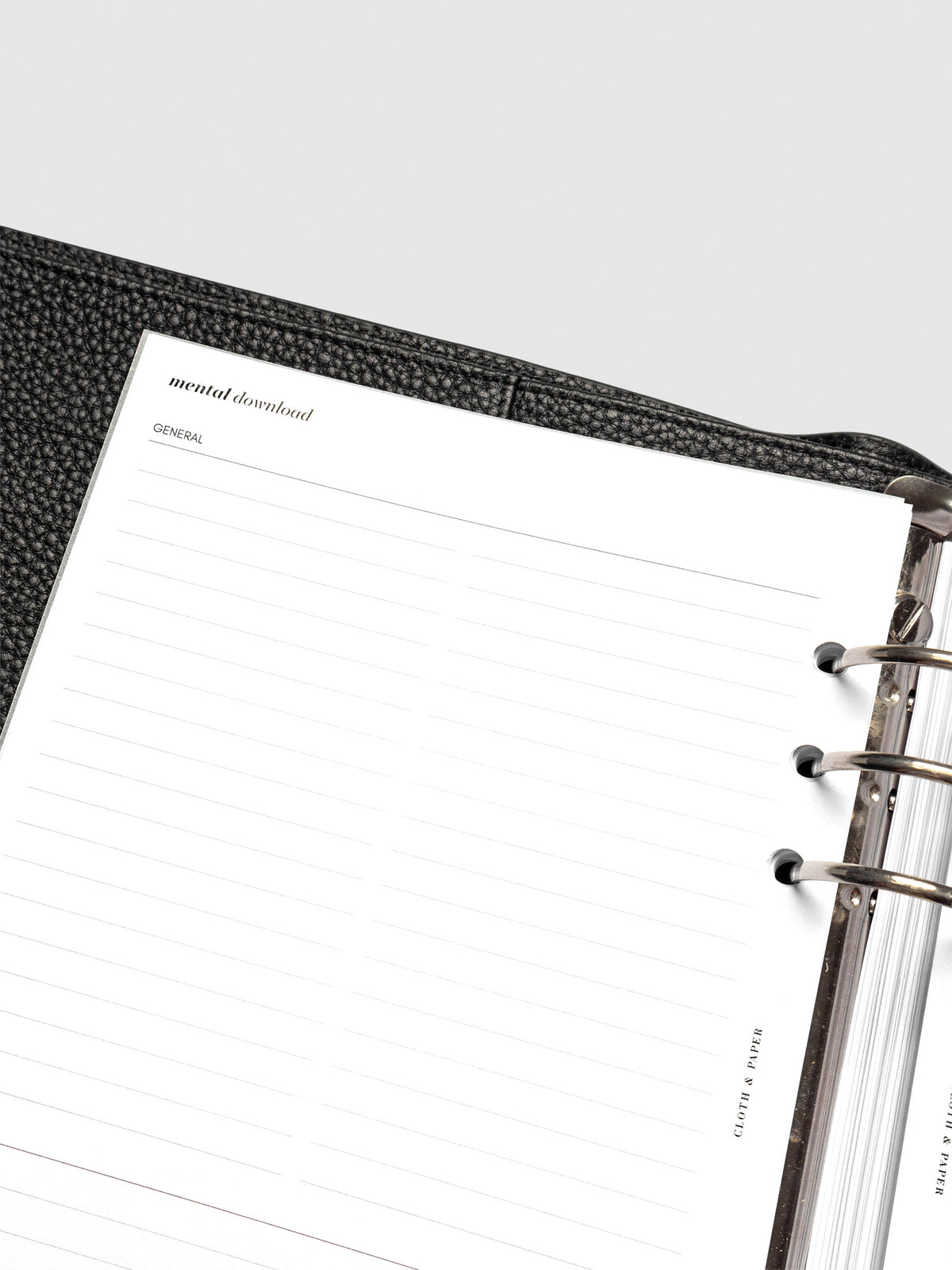 Close up of Mental Download inserts inside discbound planner and leather cover.