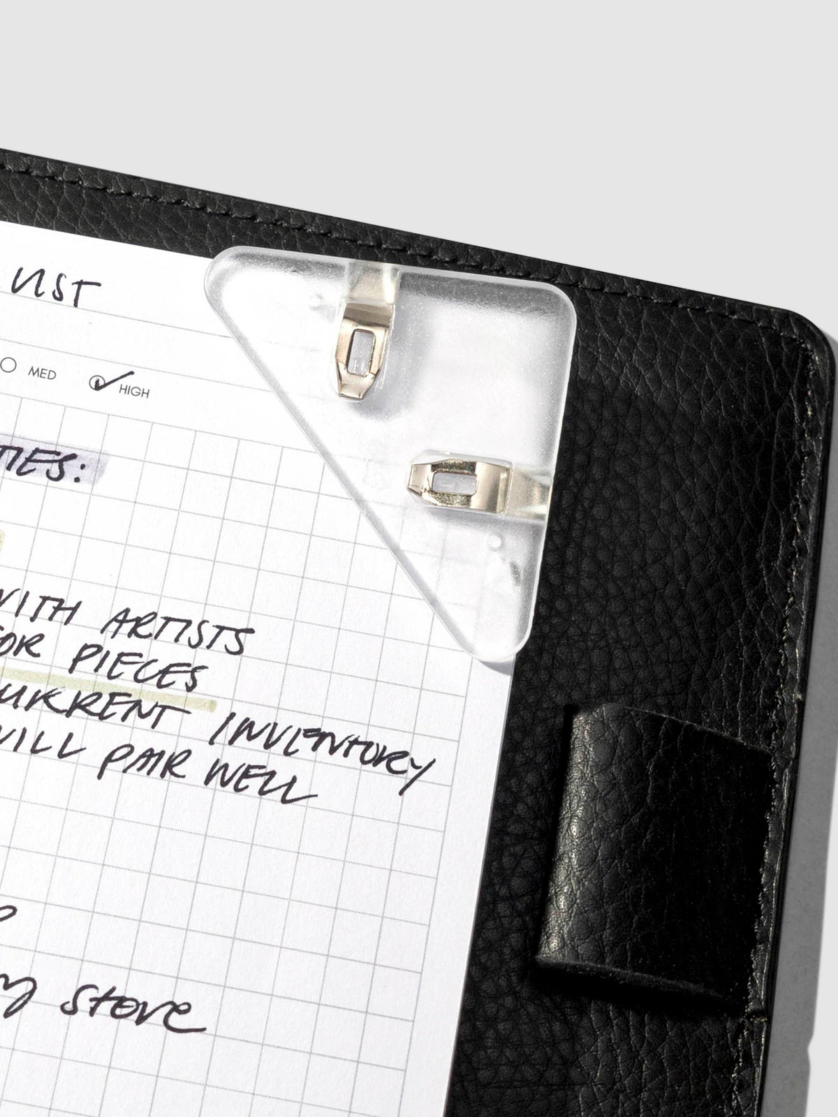 Closeup of clip inside leather folio.