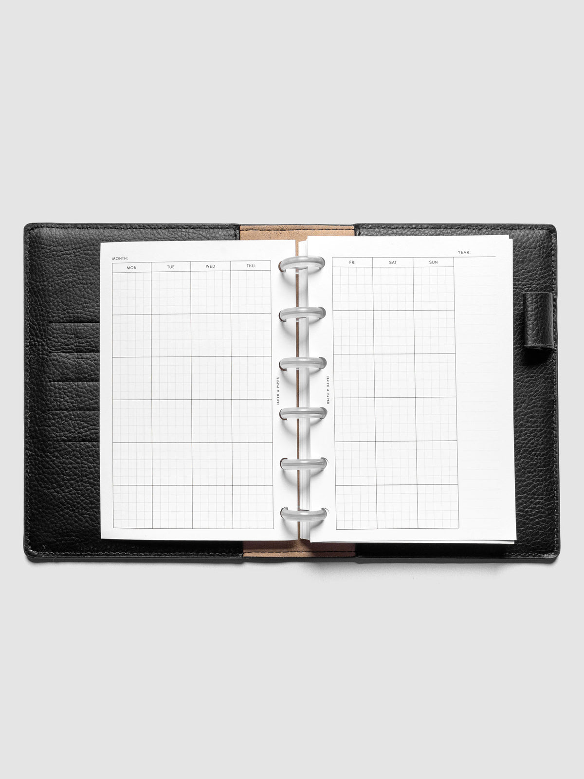 CP Petite Monthly Graph Planner Inserts shown discbound in a black leather folio.