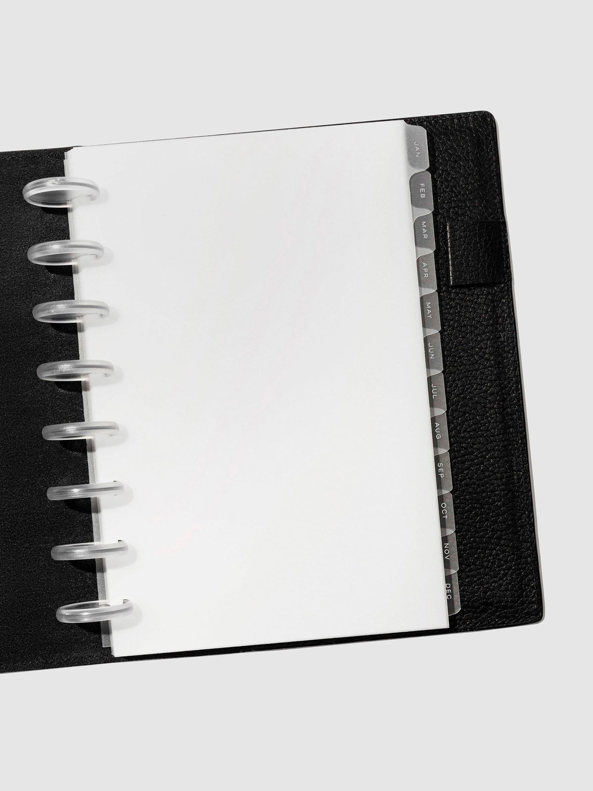 White foil tabs displayed in use inside a black leather folio.