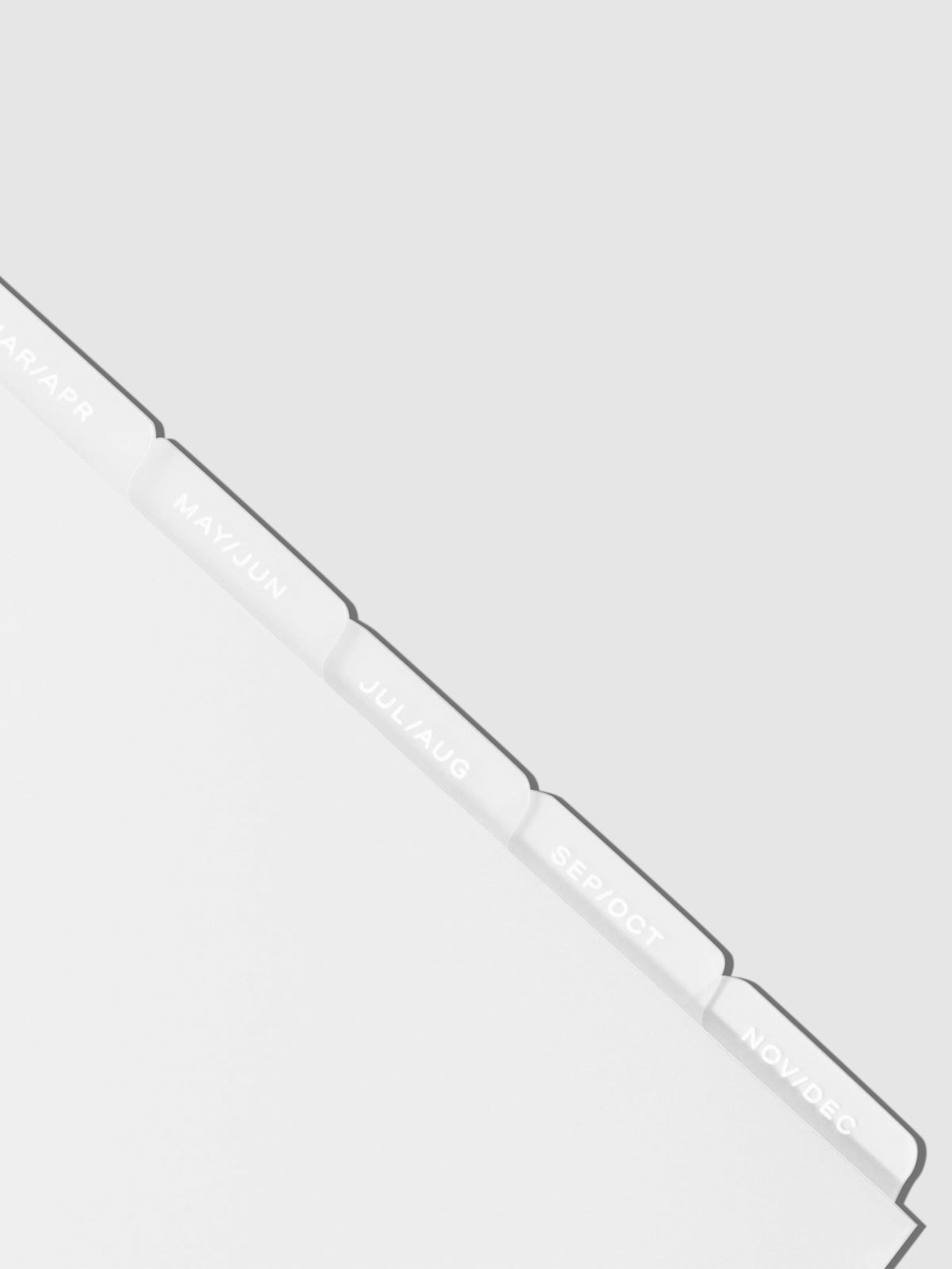 Closeup of white foil tabs displayed on a neutral background.