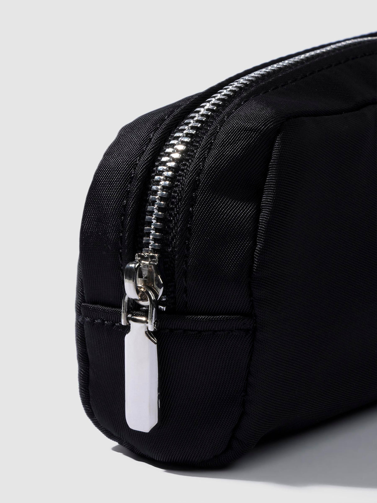 Closeup of pencil pouch's zipper. Color featured is black.