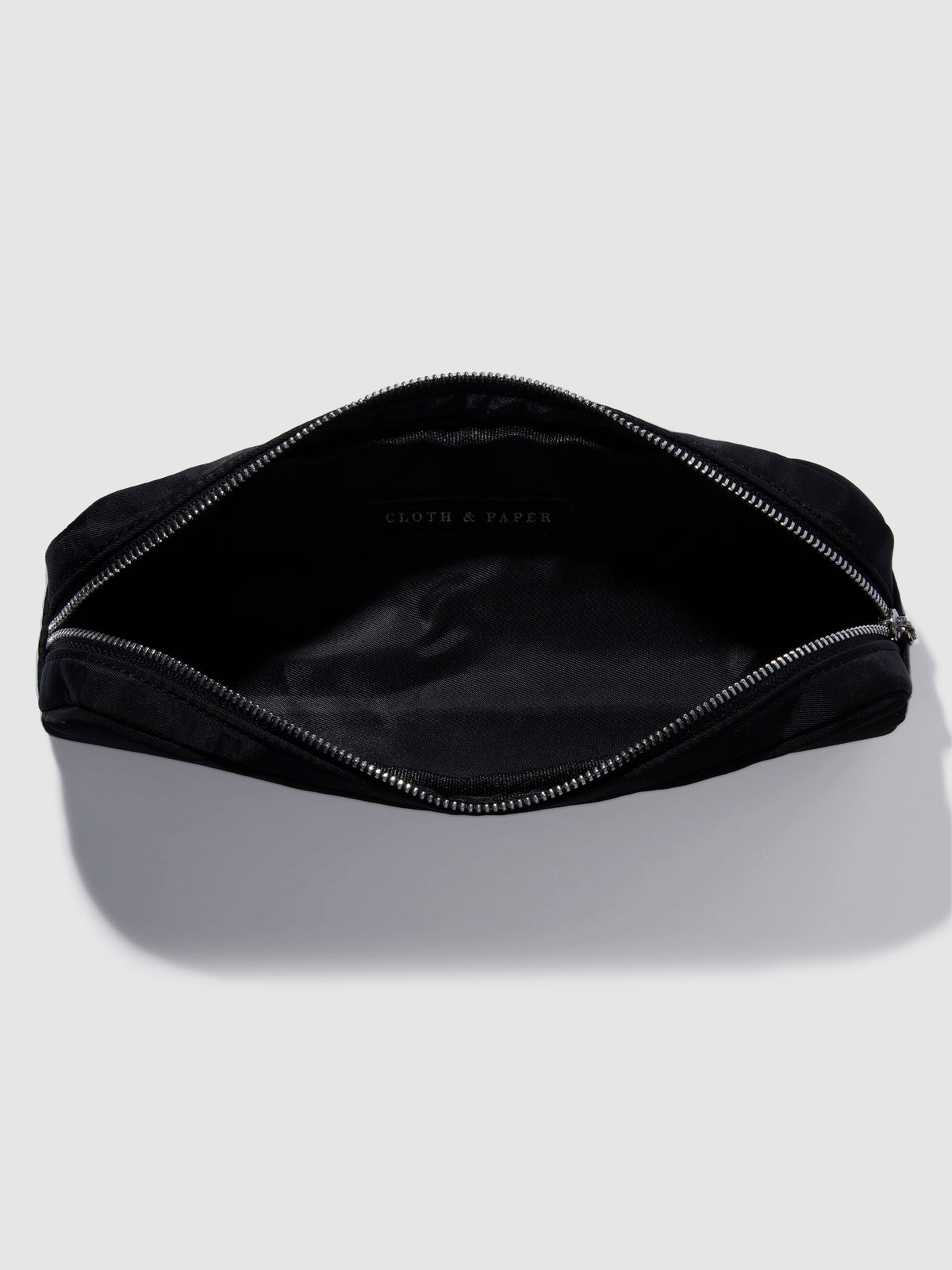 Pencil pouch displayed unzipped on a neutral background. Color featured is black.