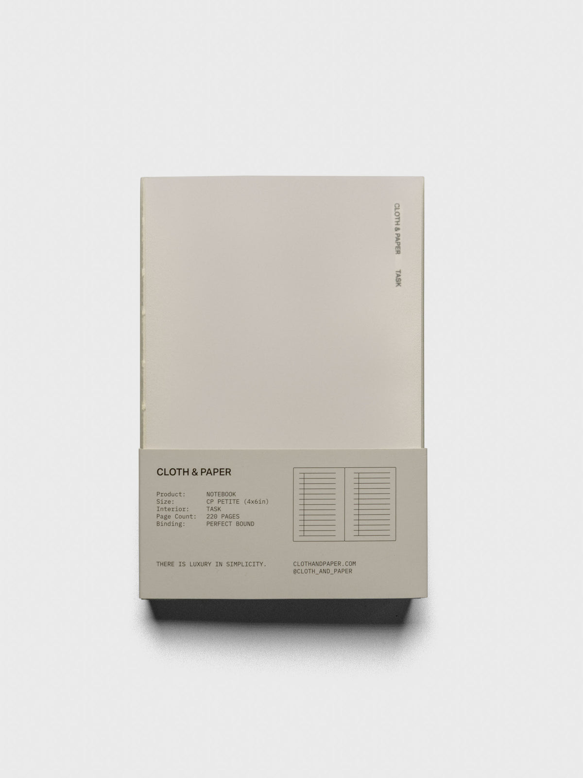 Perfect Bound Notebook | CP Petite | Task | Ristretto closed, laying flat in packaging, on a neutral background.