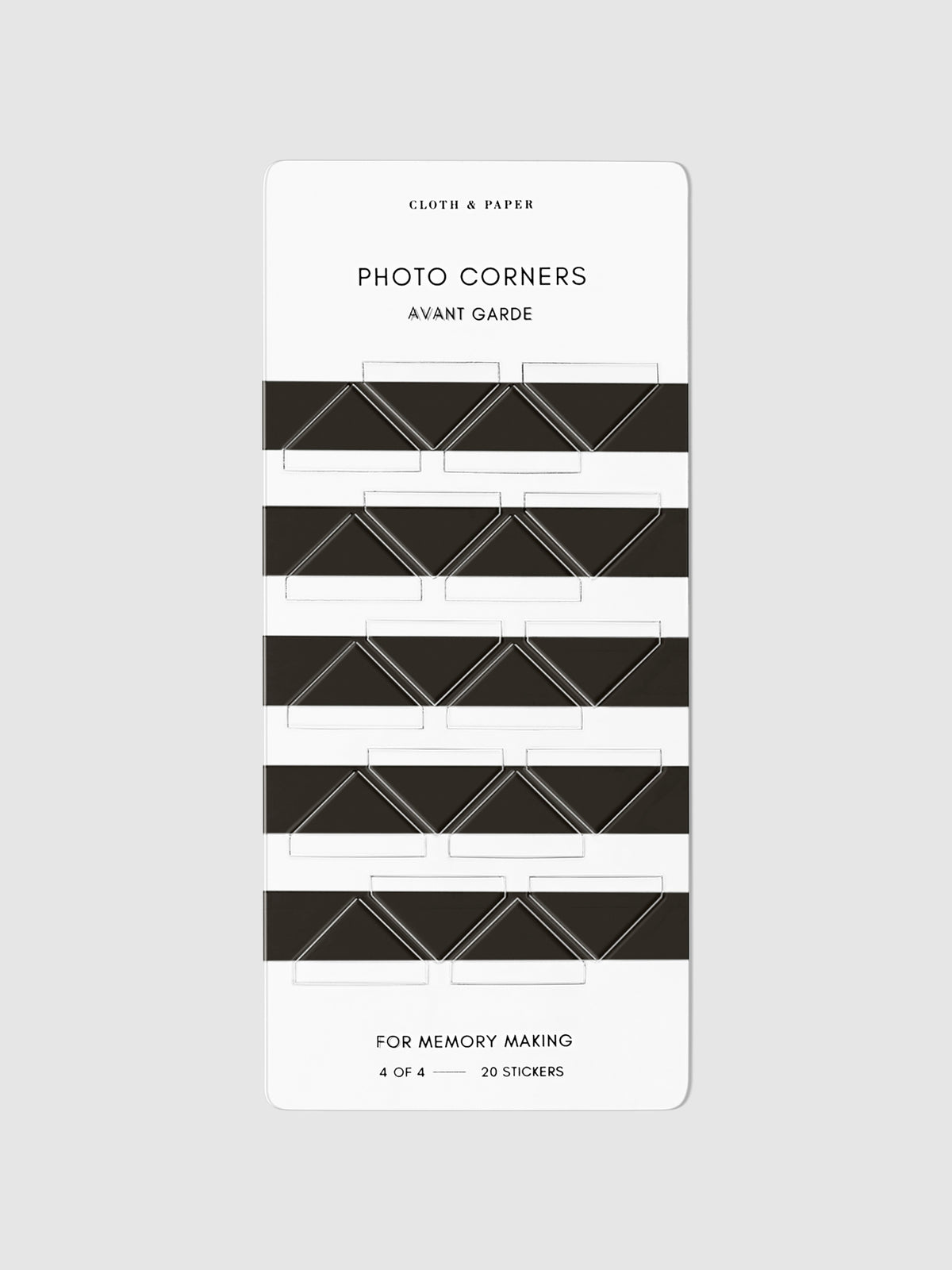 Black photo corners displayed on a neutral background.
