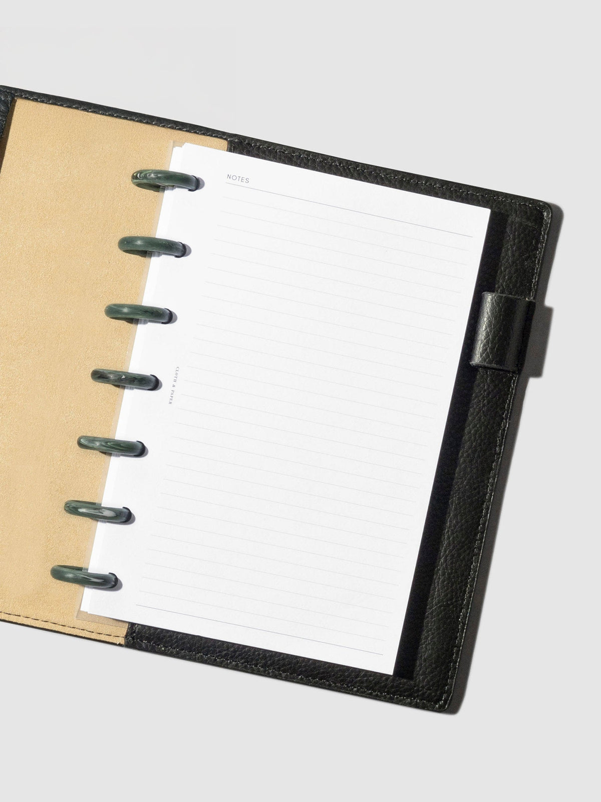 7 discs displayed inside a planner in a black leather folio.