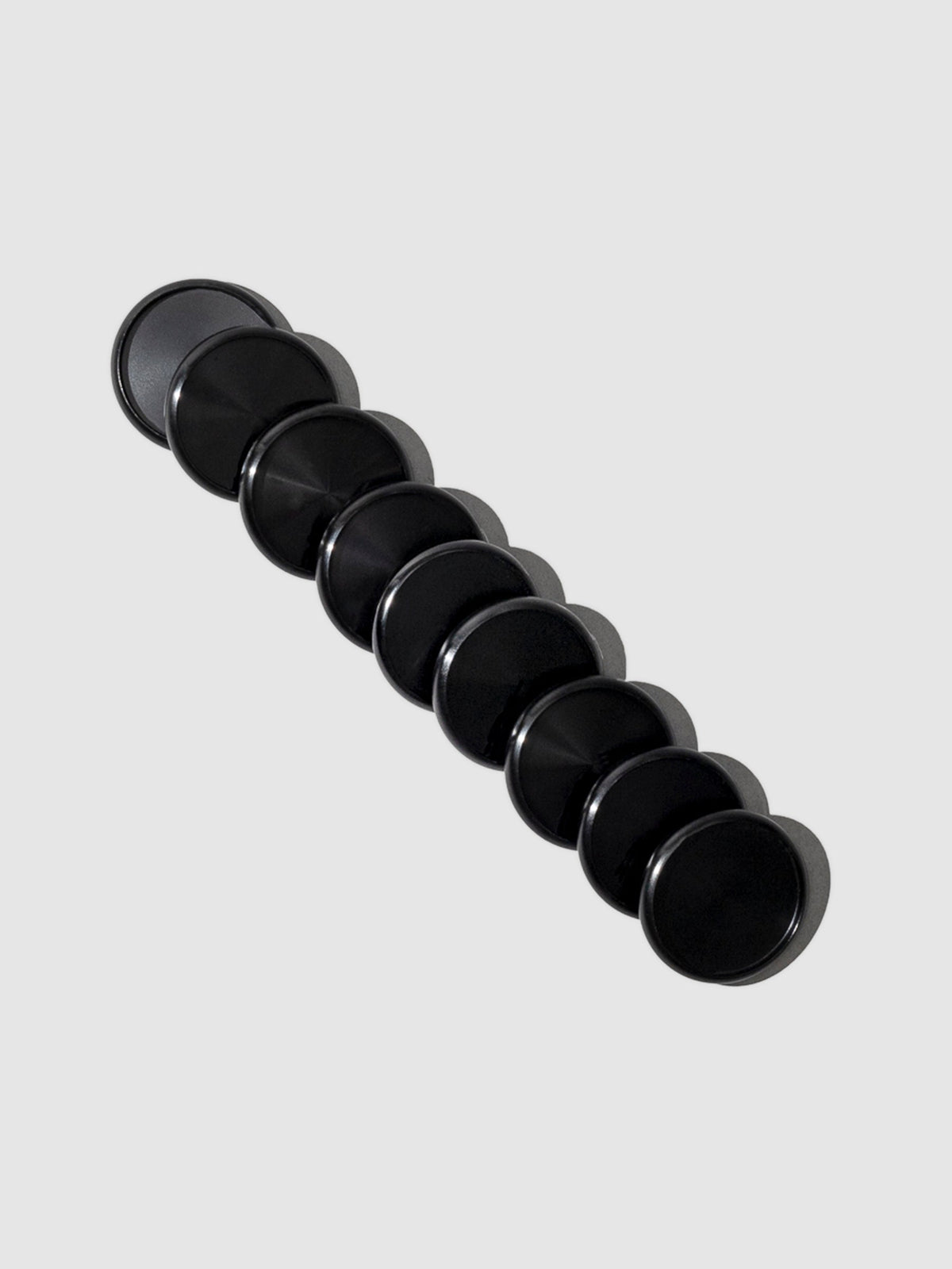 Planner Discs in Black Aluminum with a 1.25 inch diameter stacked to the left against a neutral background.