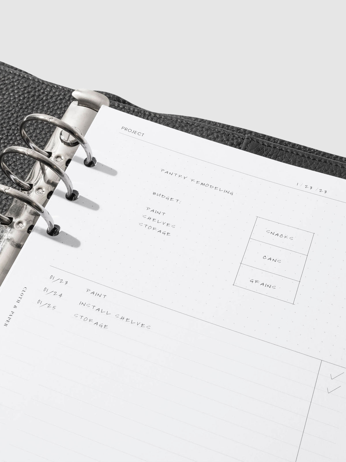 Insert in use inside of a black leather agenda. Each section is filled out with sample text. Size pictured is A5.