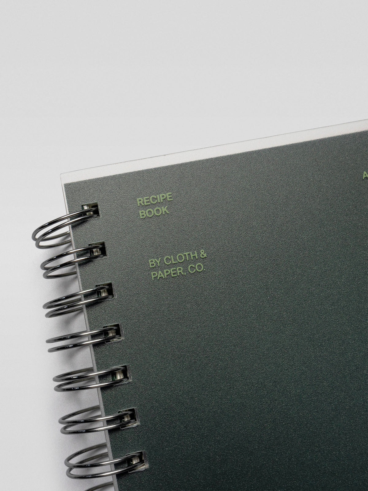 Close-up of the Recipe Book System cover showcasing the text “Recipe Book by Cloth & Paper Co.” in green lettering.