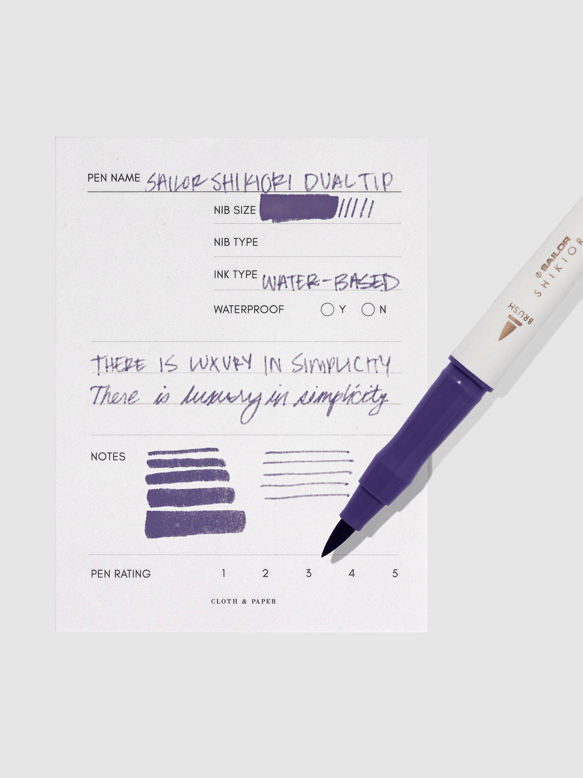 Pen displayed next to in use pen test sheet. Color pictured is Shigure.