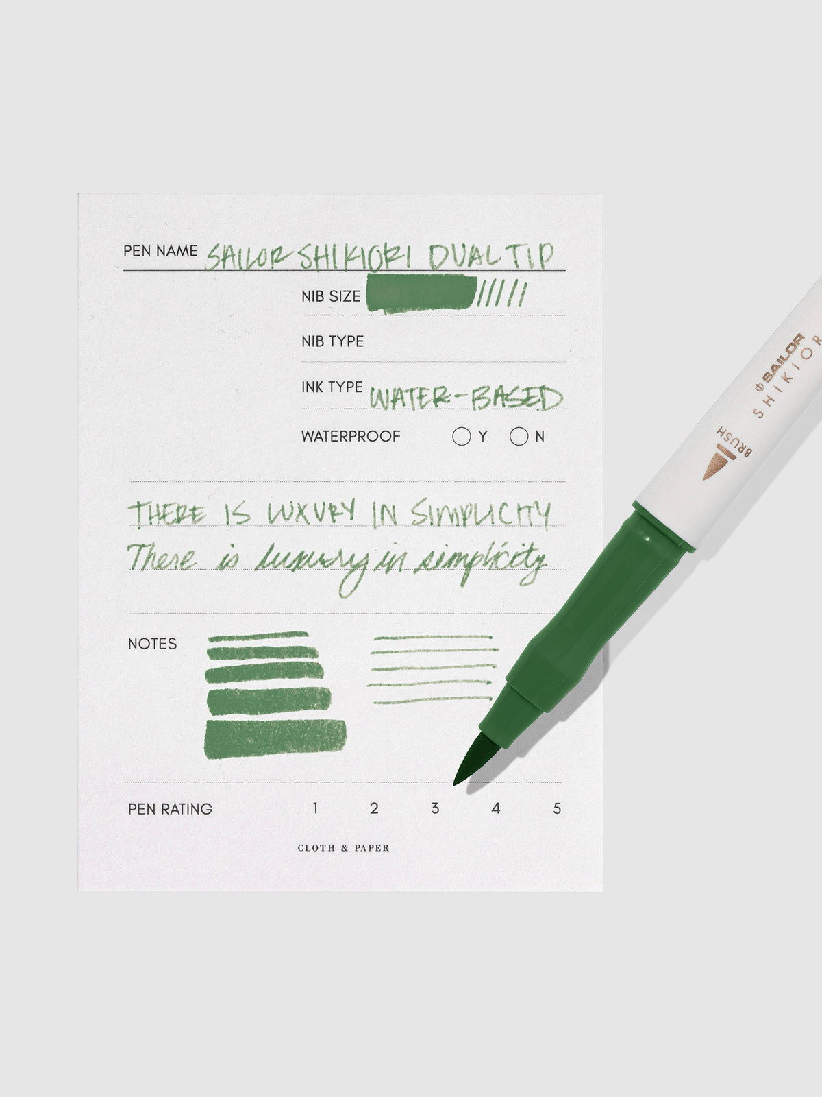 Pen displayed next to in use pen test sheet. Color pictured is Tokiwamatsu.