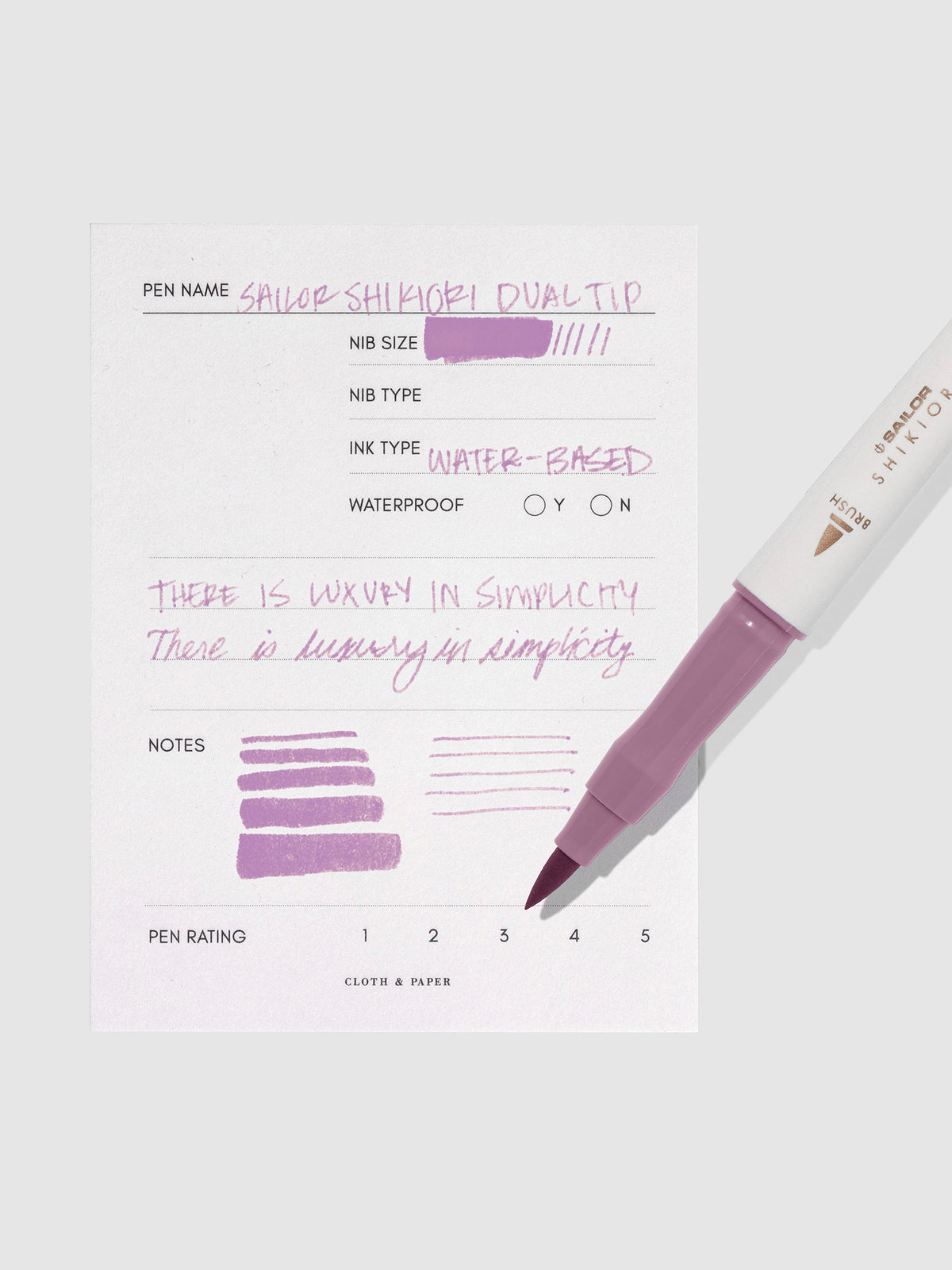 Pen displayed next to in use pen test sheet. Color pictured is Yozakura.