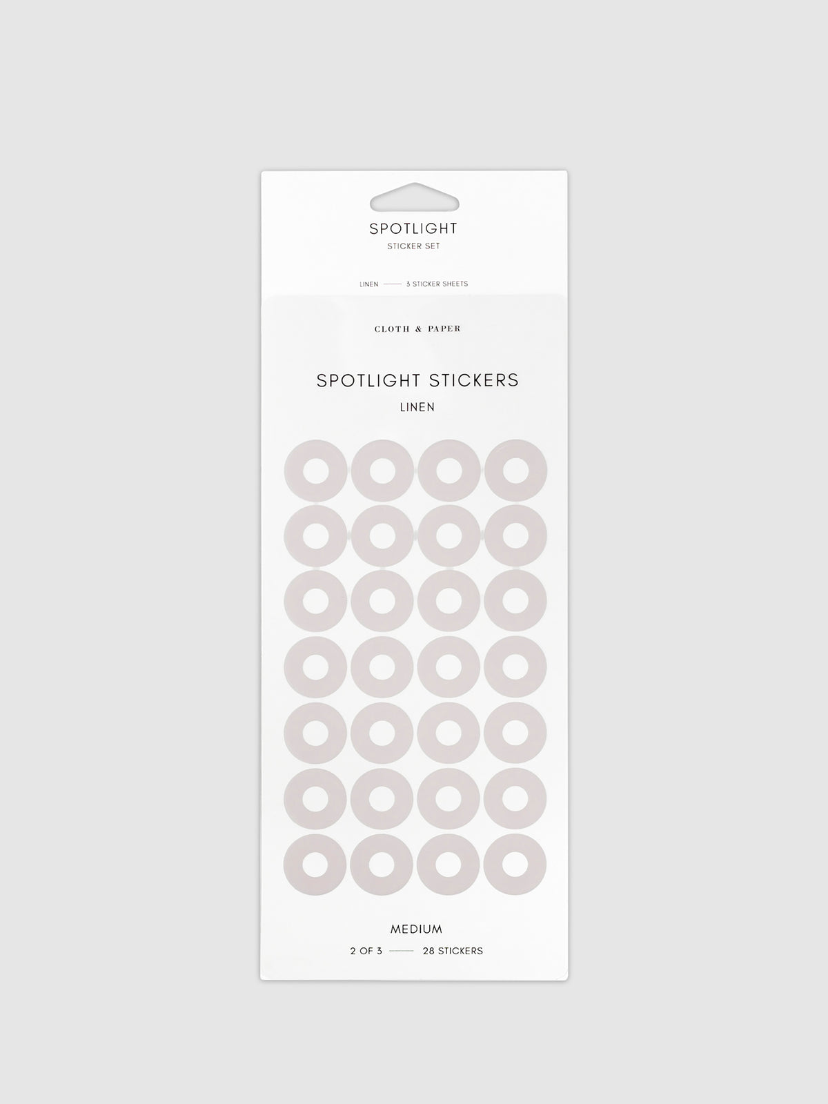 Medium sticker in its packaging displayed on a neutral background. Pictured color is linen.