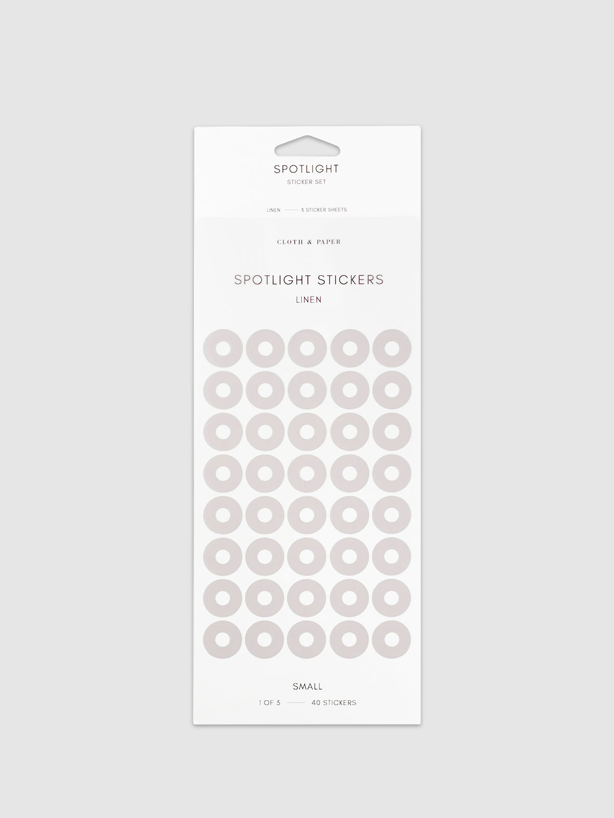 Small sticker in its packaging displayed on a neutral background. Pictured color is linen.