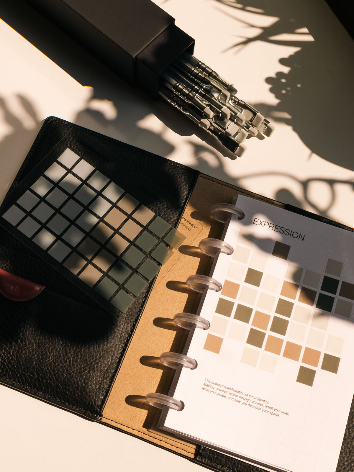 Square Stickers Vol. 2 displayed inside an open planner with Blackwing pencils nearby, showcasing their use for planning and decoration.