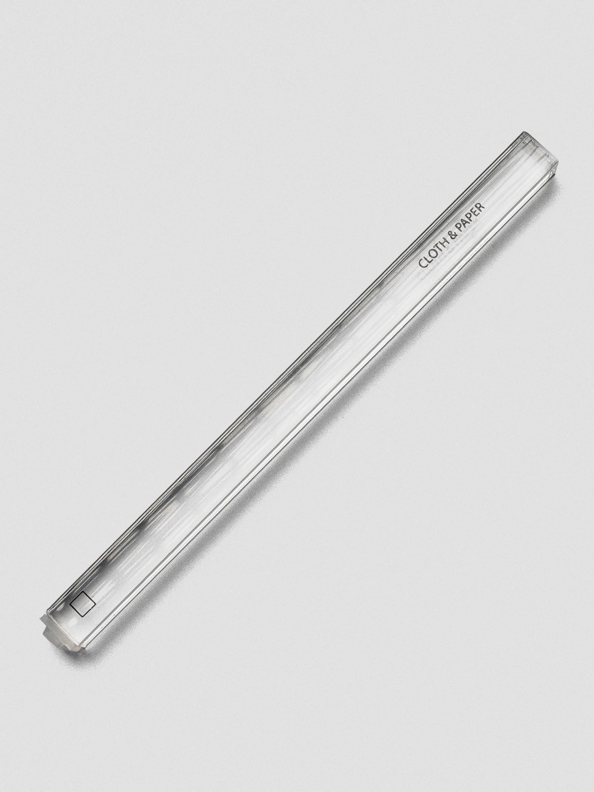 Single clear acrylic stamp stick with an outlined square icon on the end and the Cloth & Paper logo on the side.