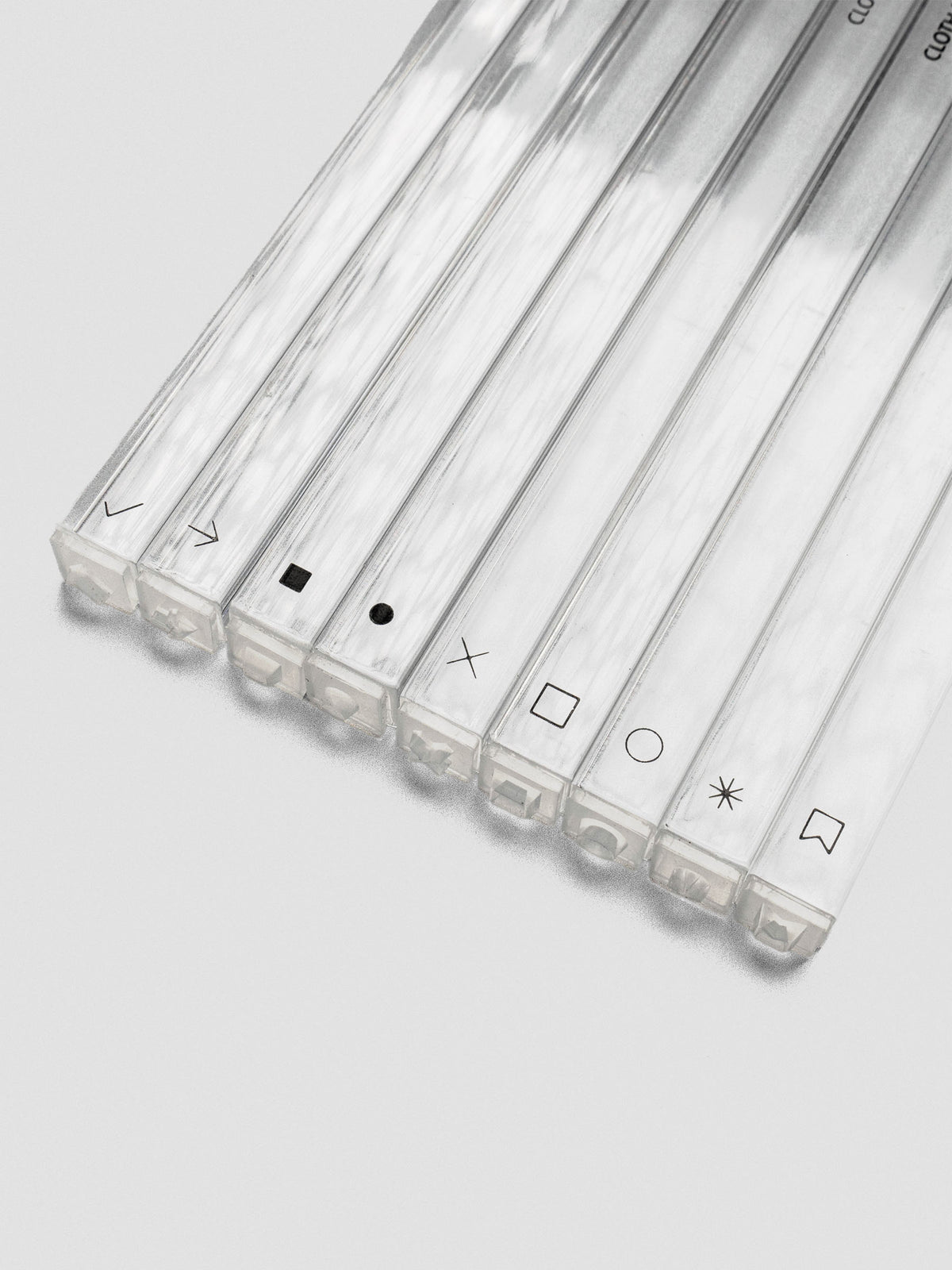 Angled view of stamp sticks lying flat, icons facing forward, showcasing the clear acrylic sides.