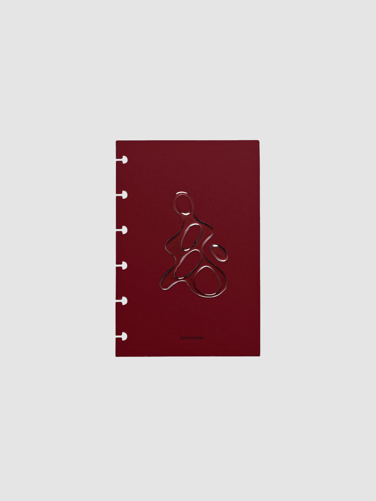 Dark red, semi-transparent, and glossy plastic planner dashboard with organic raised shape design in size CP Petite on a neutral background.