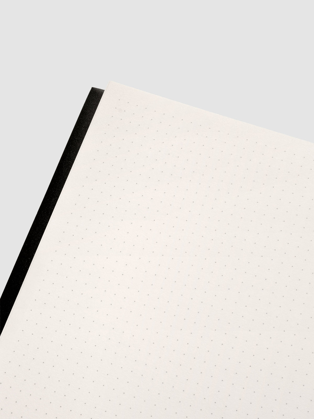 Close up of the Perfect Bound Notebook | A5 | Dot Grid | Avant Garde shown open, laying flat, displaying the dot grid layout.