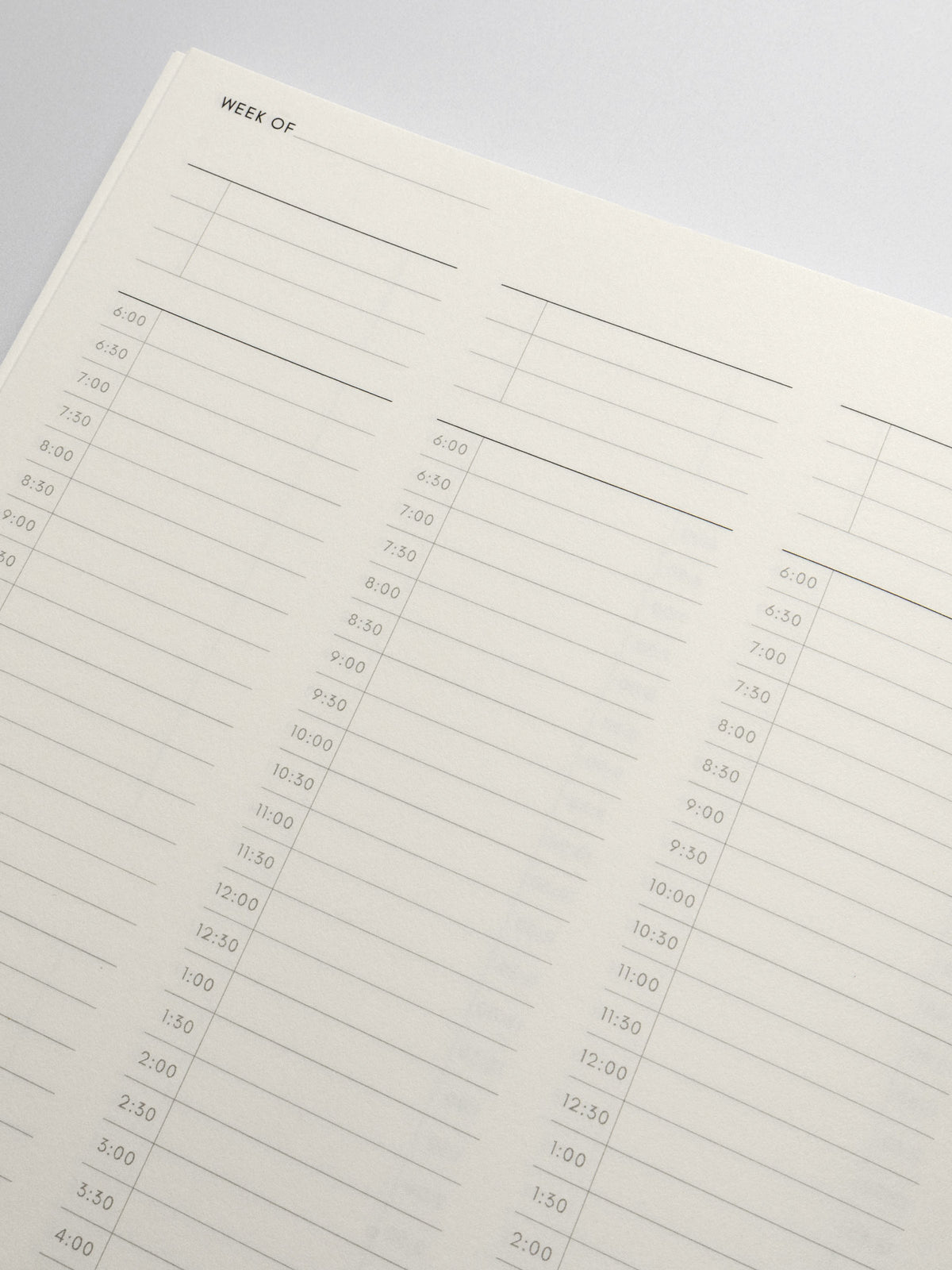 Perfect Bound Notebook in size HP Classic with 30 Minute Time Block pages shown close up with an undated label for the week and 30 minute blocks starting at 6:00.