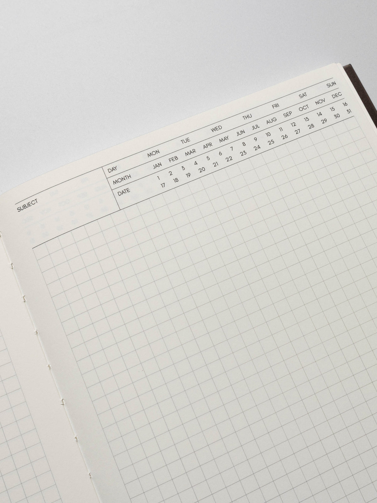Perfect Bound Notebook in size HP Classic with Executive Notes pages shown close up to display the fields to write subject and mark day, month, and date with open grid note space for note taking below.
