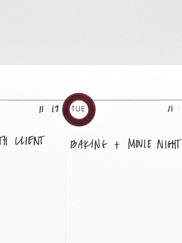 One Bordeaux Spotlight Sticker | High Gloss on a planner insert page used to highlight the day of the week.