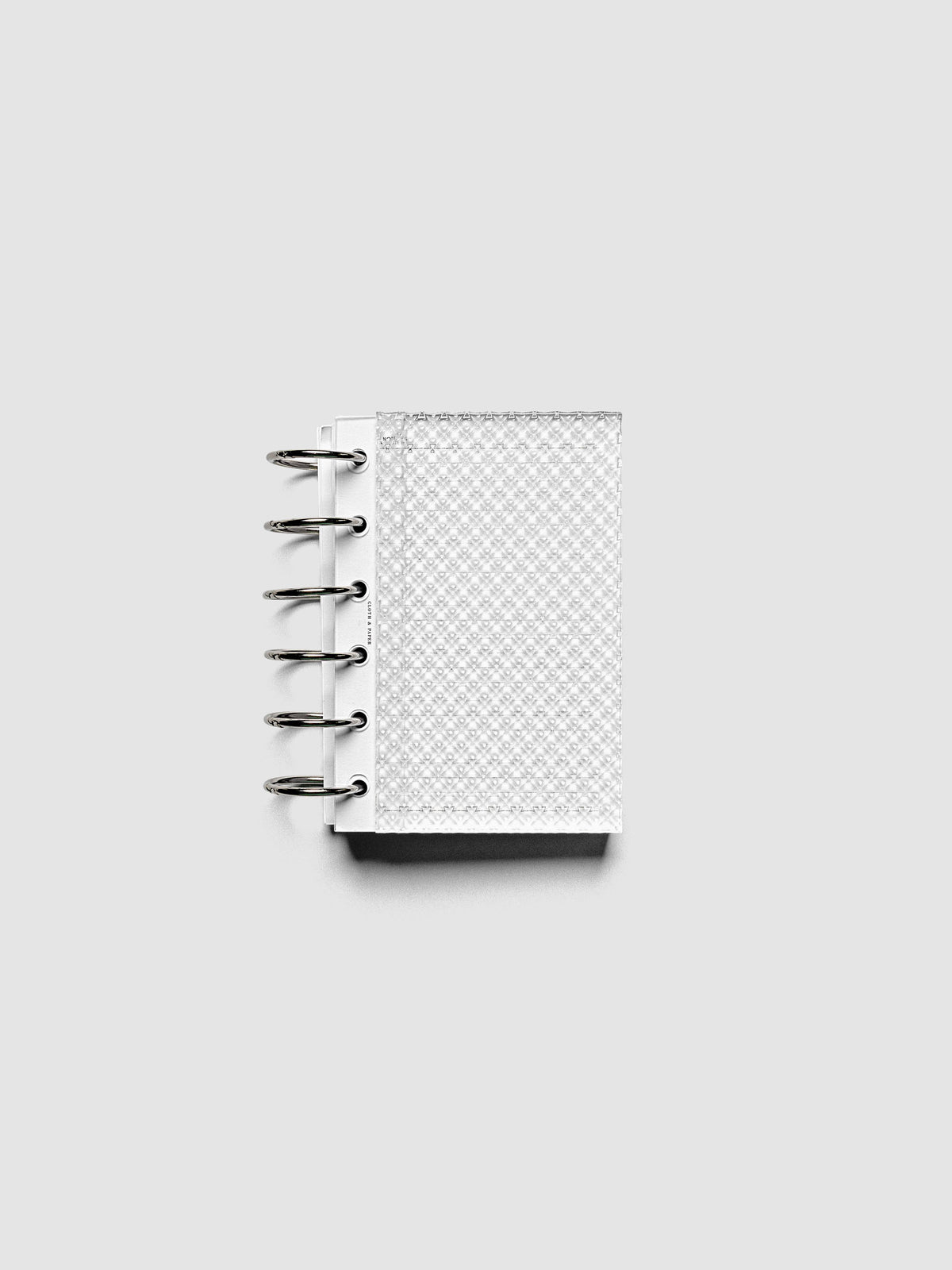 Clear, textured Studded Planner Dashboard in the size Pocket, shown ringbound.