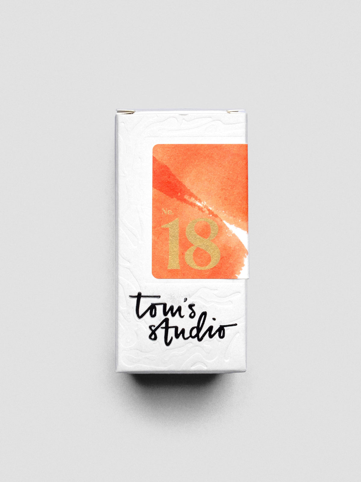 Tom’s Studio Fountain Pen Ink in Marmalade, emphasizing vibrant orange shade shown in packaging.