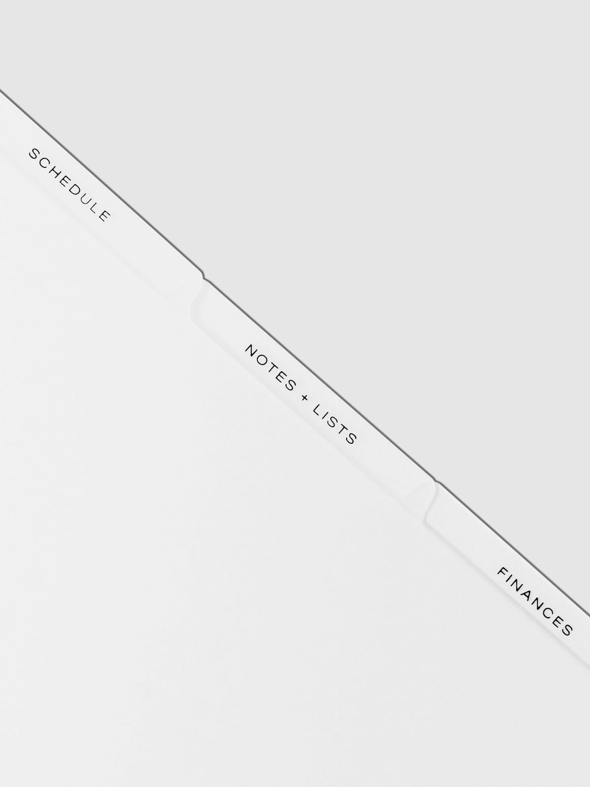 Closeup of black tab dividers displayed on a neutral background.
