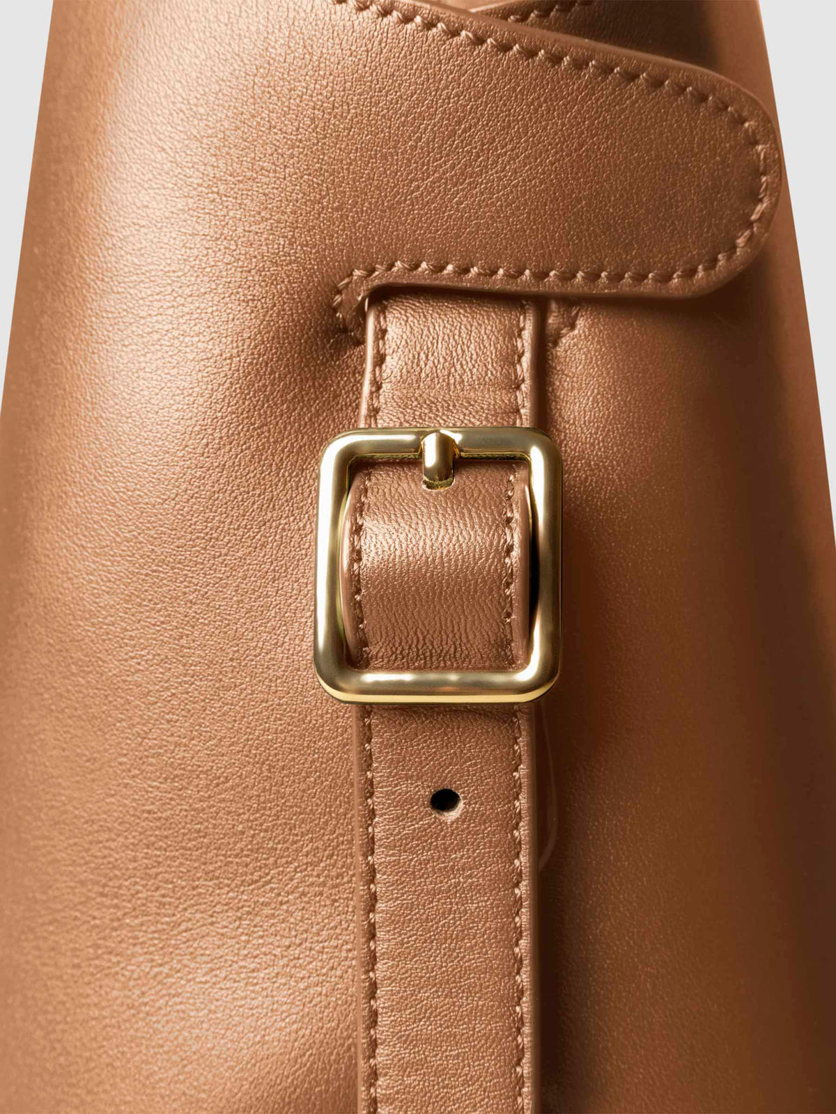 Side view of bag showcasing its gold hardware and adjustable leather strap. Color shown is Alhambra.
