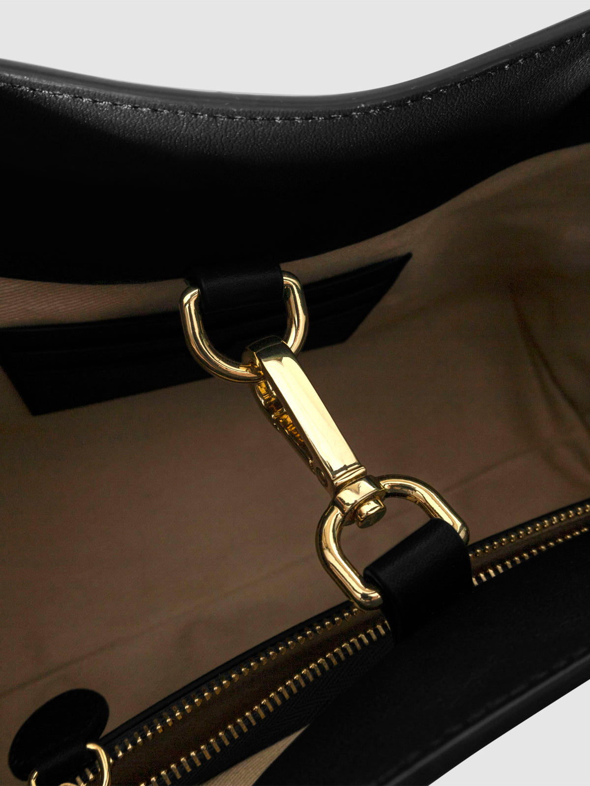 Top down view of bag showcasing its gold hardware. It secures the bag shut. Color shown is Padrillo.
