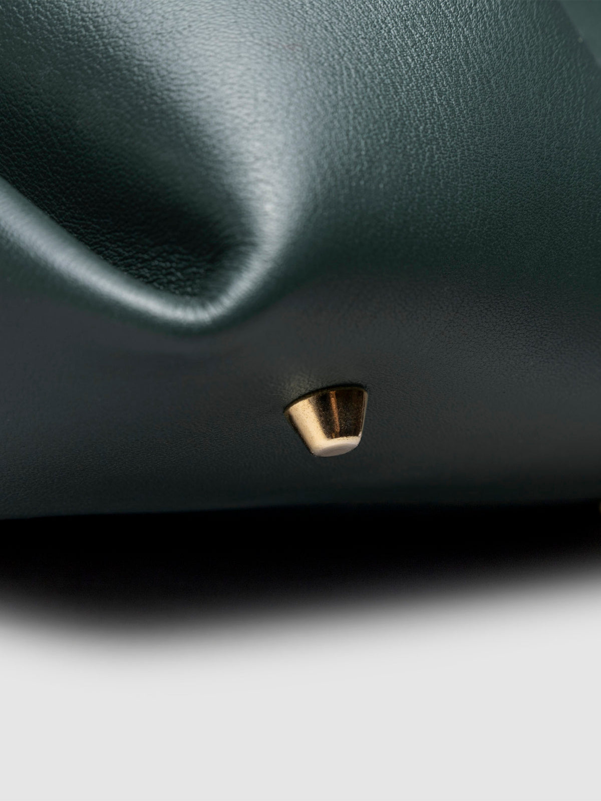 Closeup of the gold feet on the bottom of the bag. Color shown is Salamanca.