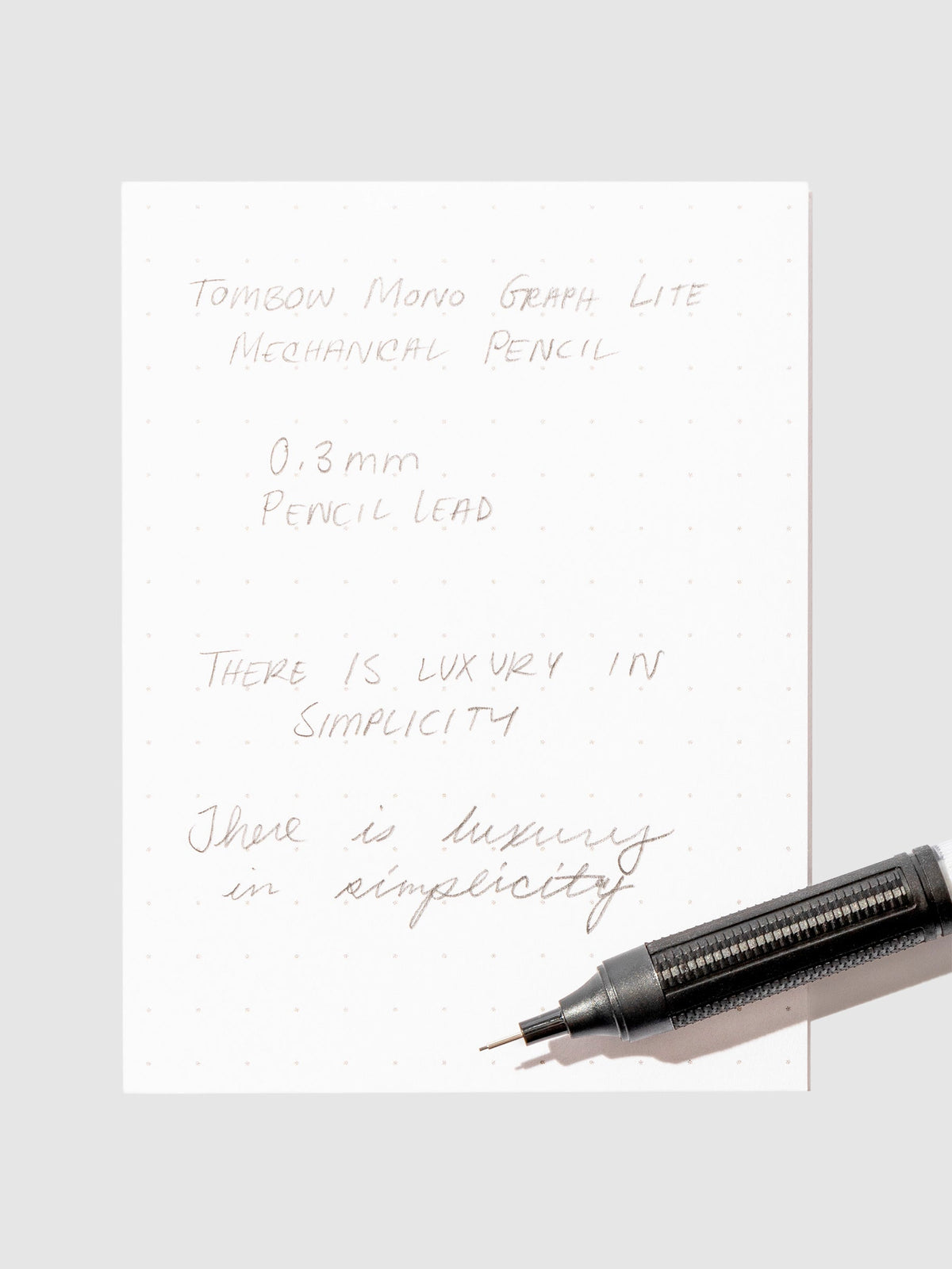 Writing sample with pencil displayed on a background.eutral
