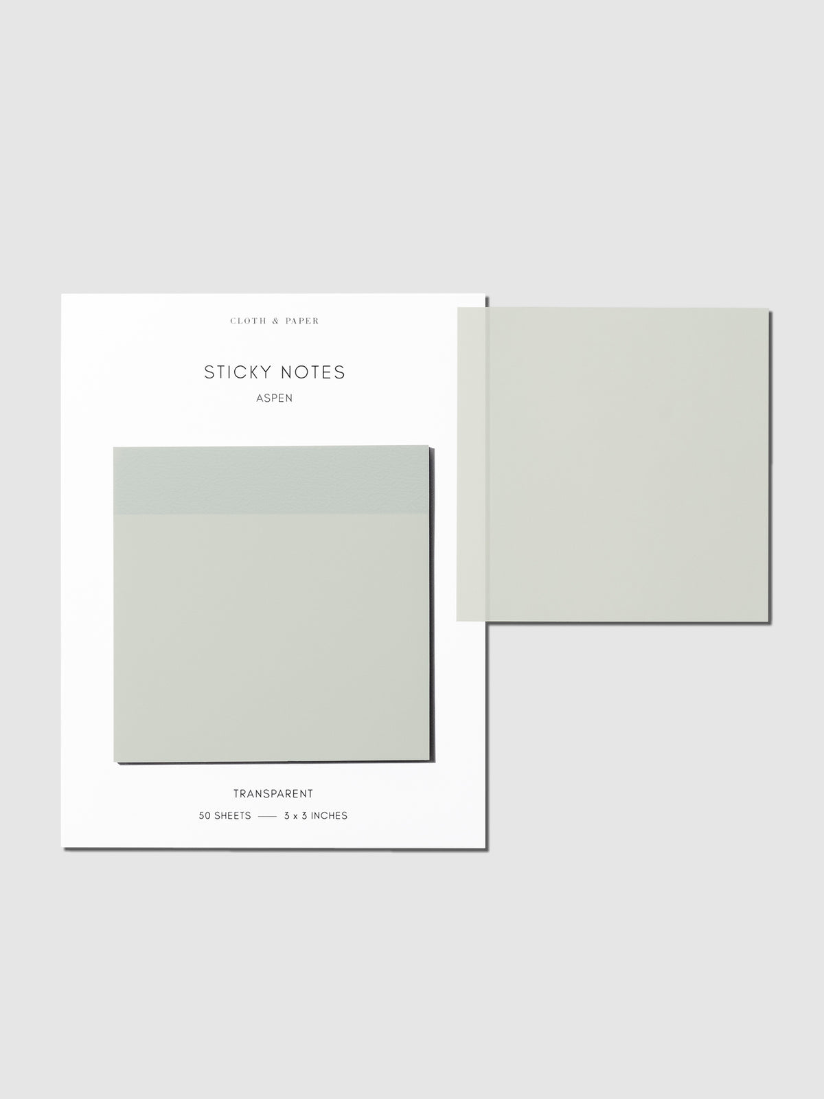 Sticky notes on their backing displayed on a neutral background. One sticky note is displayed on the corner of the backing to show its transparency. Color pictured is Aspen.