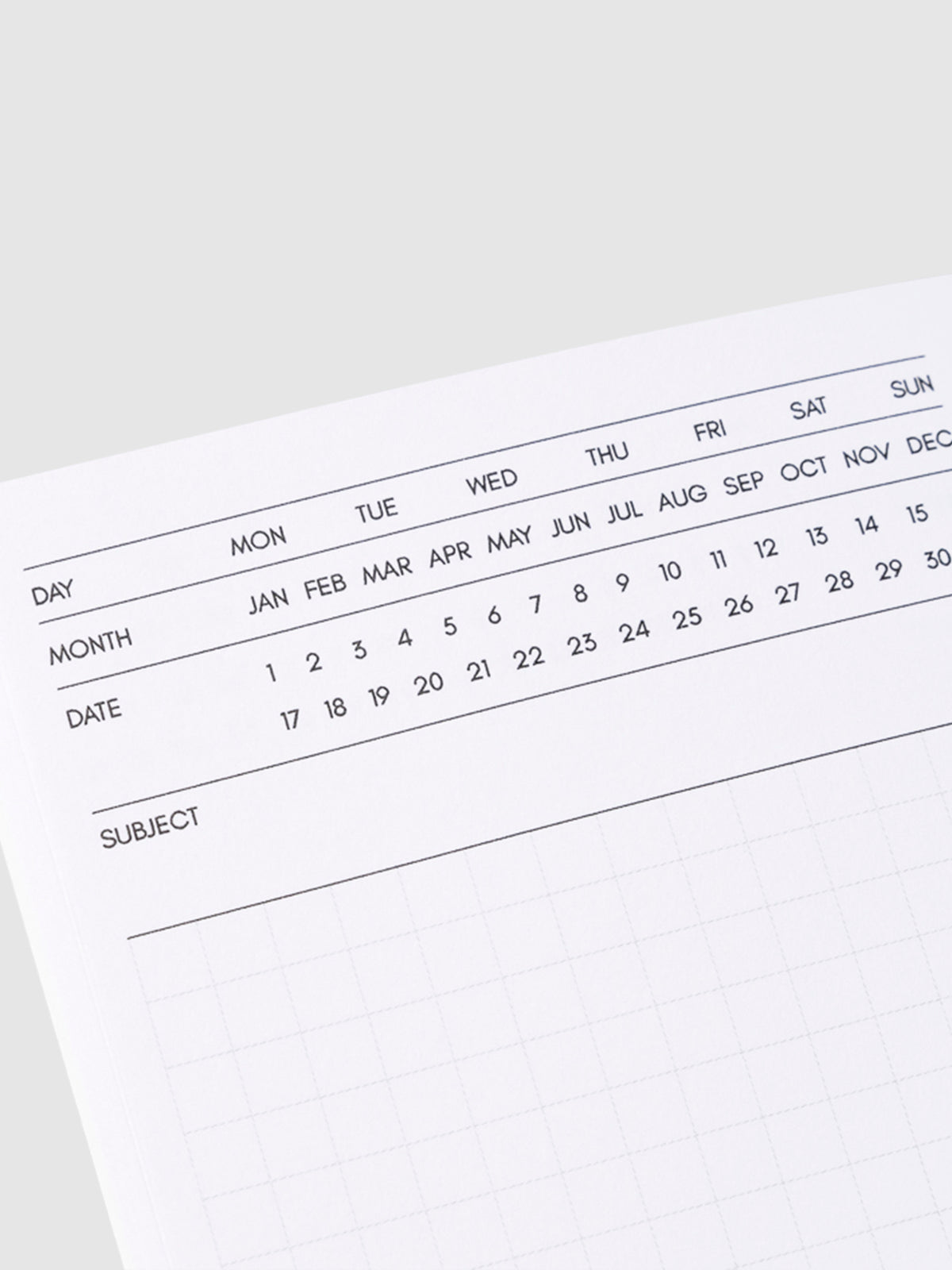 Close up image of the top left corner of the executive notebook page. The page is turned on a left angle and is displayed on a light gray background
