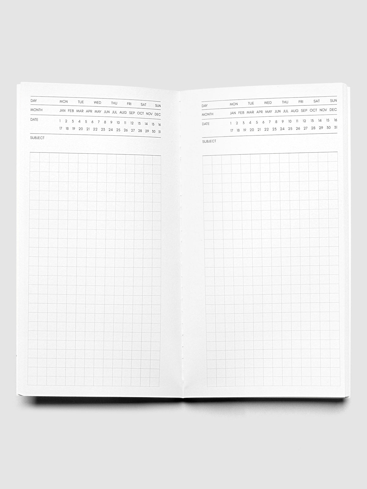 Travel Notebook | Pocket Plus | Cafe Noir | Executive shown open displaying Executive Notes style inserts with graph note space and headers for the day, month, date, and subject.