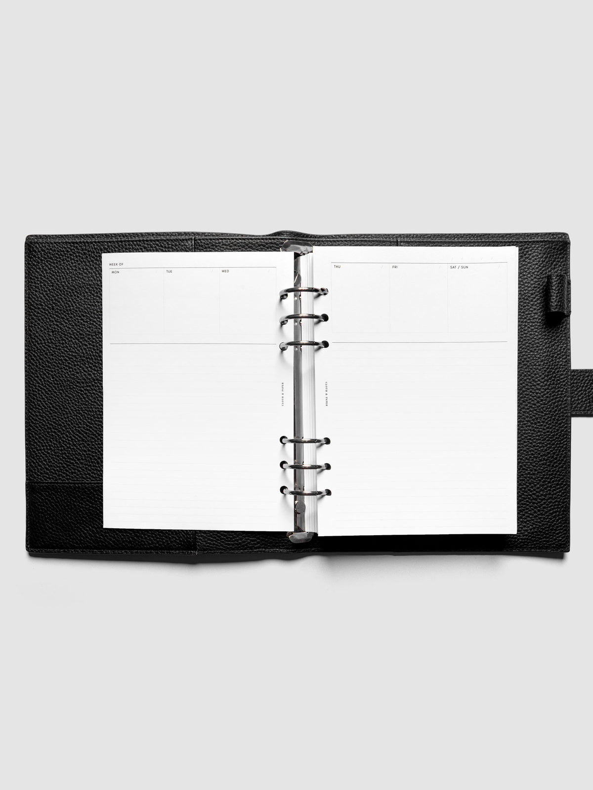 A5 Undated Weekly Notes Planner Inserts ringbound in a black leather agenda.