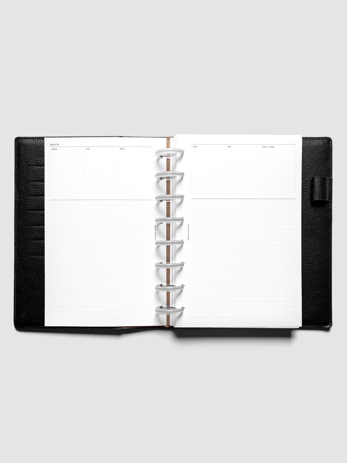 Half Letter Undated Weekly Notes Planner Inserts discbound in a black leather folio.