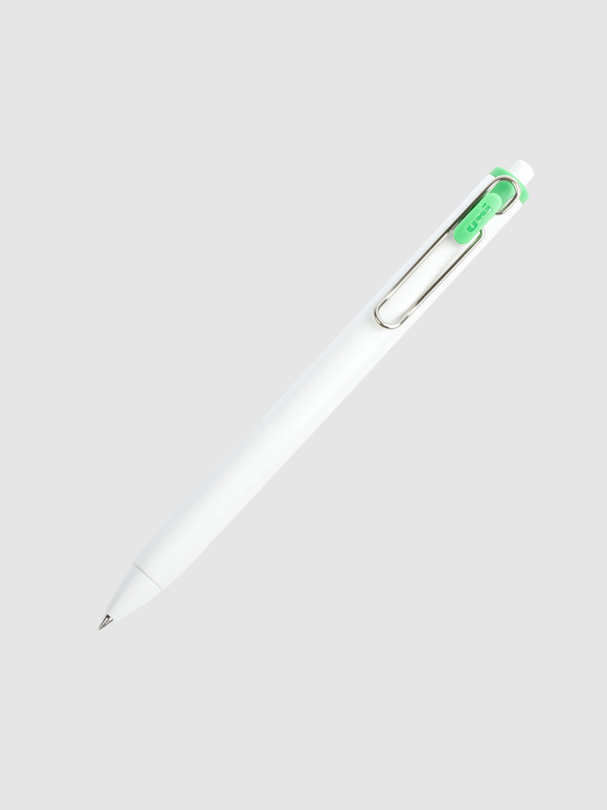 Uni-ball One Gel Pen, Palm Green, Cloth and Paper. Pen tilted slightly to the right on a neutral background.
